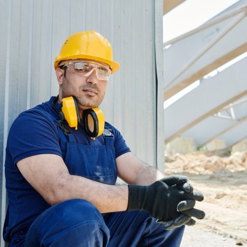 A Man in Blue Shirt Wearing a Yellow Hard Hat